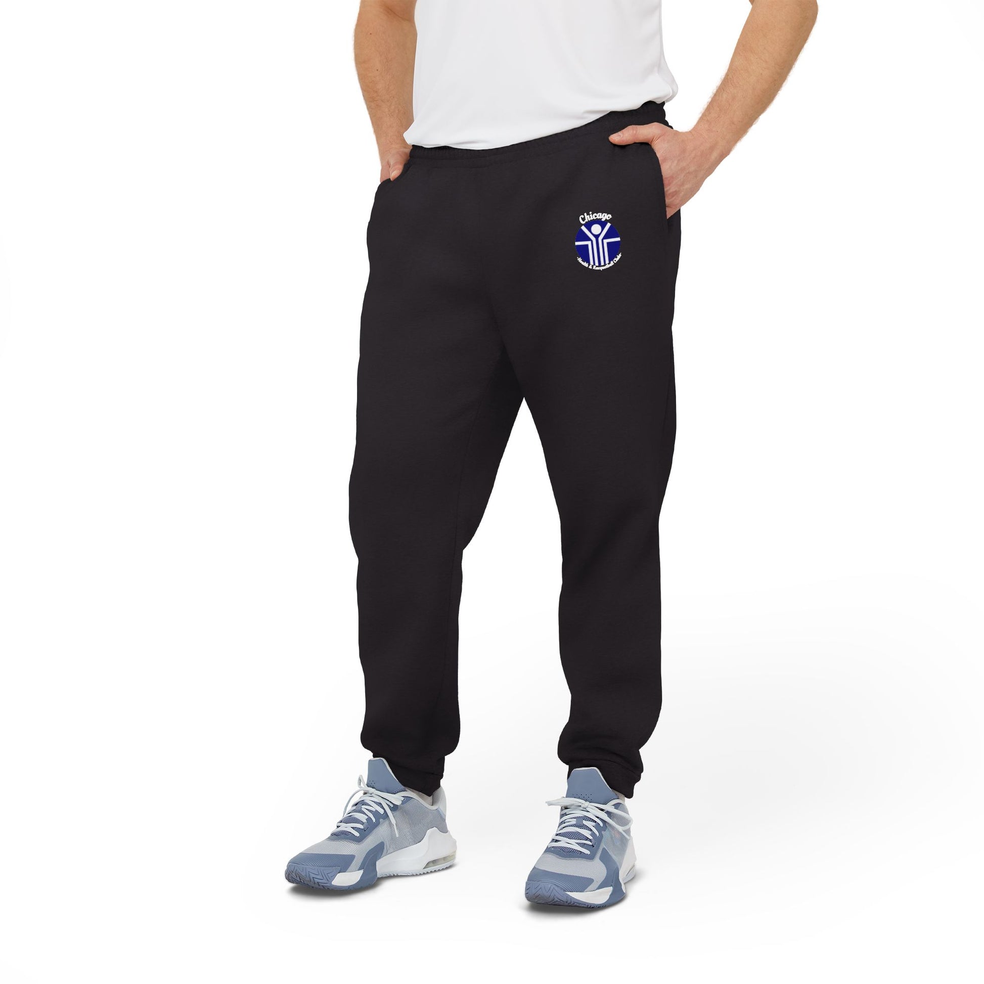 Gray Adidas unisex fleece joggers from Printify, showcasing the classic Chicago Health Clubs - Bally's 1980s logo on the left thigh and a blue and white emblem on the right. Crafted from sustainable BCI cotton, these joggers feature an elastic waistband and cuffs for maximum comfort.