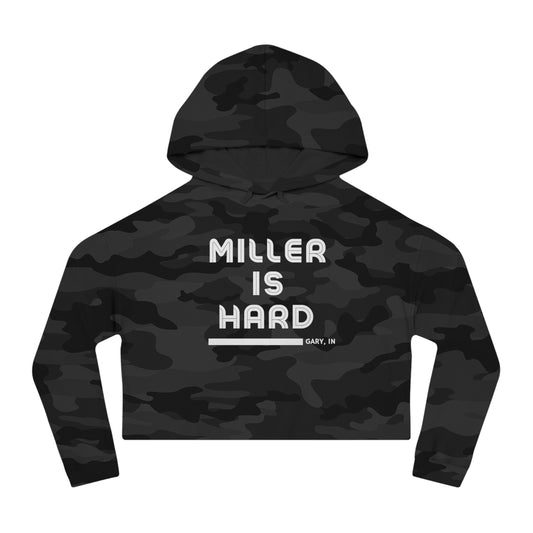 A black and gray camouflage women's crop hoodie, adorned with the striking text "Miller Is Hard" in white and the location "Gary, IN" subtly included beneath it. Exclusively available from Printify.