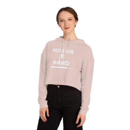A black and gray camouflage women's crop hoodie, adorned with the striking text "Miller Is Hard" in white and the location "Gary, IN" subtly included beneath it. Exclusively available from Printify.