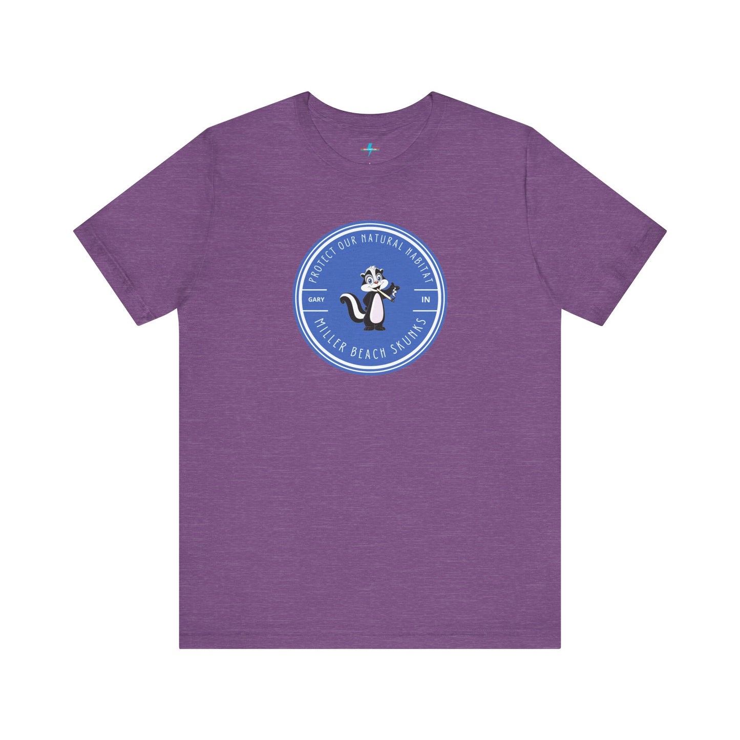 The Printify Miller Beach Skunks - Unisex Jersey Short Sleeve Tee is a gray T-shirt that features a circular blue logo at the center. Inside the logo, there is an illustration of a skunk with the text "Protect Our Habitat" and "Miller Beach Skunks" around the border, promoting environmental consciousness. The upper left part of the logo reads "Gary, IN.