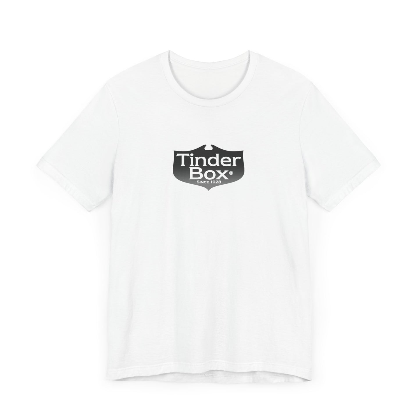A light blue Printify "The Tinder Box 1980s" unisex jersey short sleeve tee featuring the "Tinder Box" logo in the center. The logo consists of a dark shield with the words "Tinder Box" in white text, with a small flame icon replacing the dot above the "i".