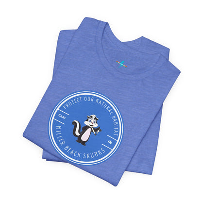 The Printify Miller Beach Skunks - Unisex Jersey Short Sleeve Tee is a gray T-shirt that features a circular blue logo at the center. Inside the logo, there is an illustration of a skunk with the text "Protect Our Habitat" and "Miller Beach Skunks" around the border, promoting environmental consciousness. The upper left part of the logo reads "Gary, IN.