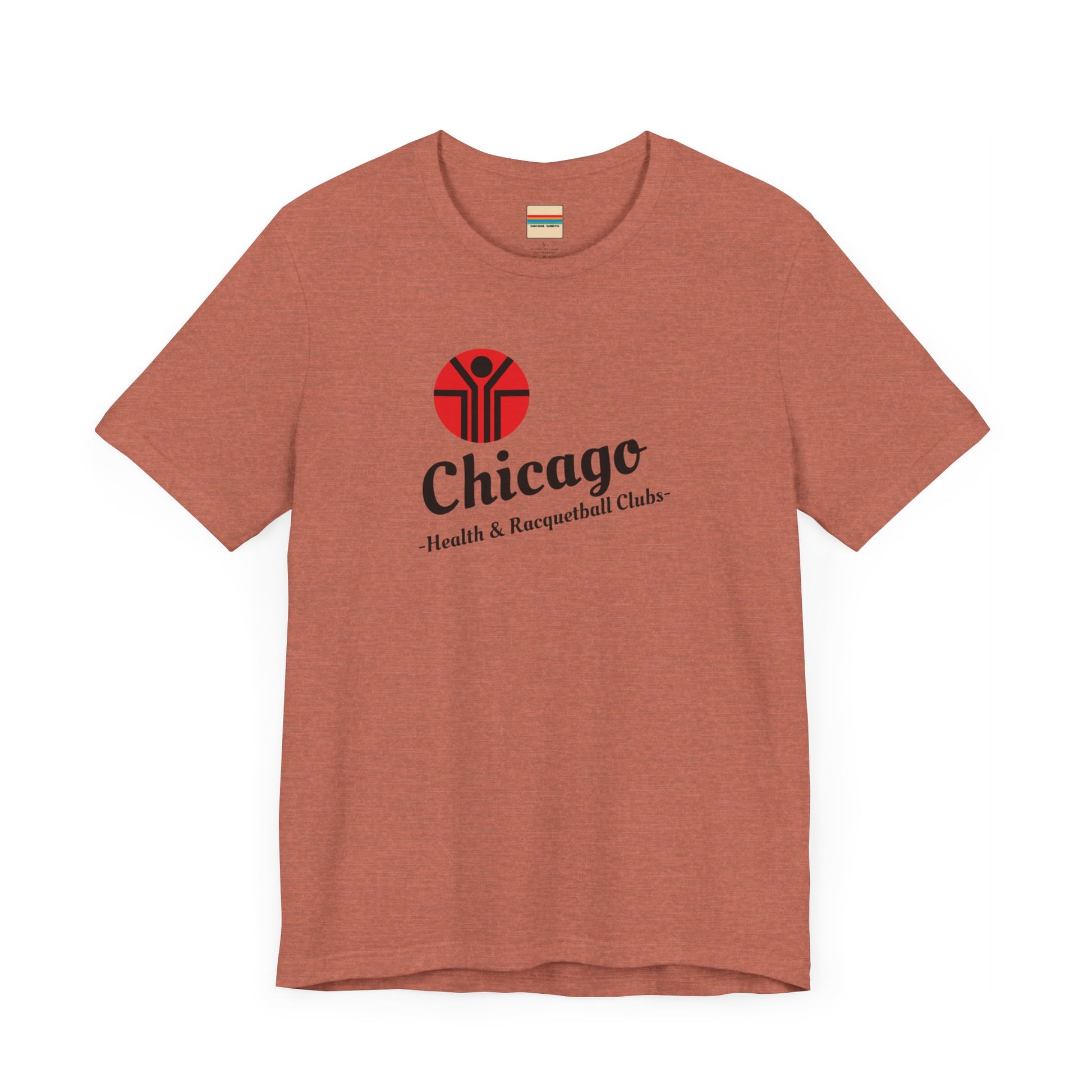 Two gray T-shirts are neatly folded on top of each other, with the top shirt showcasing the text "Chicago Health & Racquetball Clubs" in black below a red logo featuring a person with raised arms inside a circular design. This retro-inspired tee, named "Chicago Health Clubs 1980s Retro - Unisex Jersey Short Sleeve Tee" by Printify, is perfect for any fan of Chicago Health Clubs.