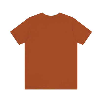 A unisex jersey short sleeve tee from Printify in burnt orange features the bold black text "MILLER IS HARD" on the chest, with "GARY, IN" written beneath in smaller black font. Perfect for showcasing Miller Beach's iconic spirit, this t-shirt is displayed against a plain white background.