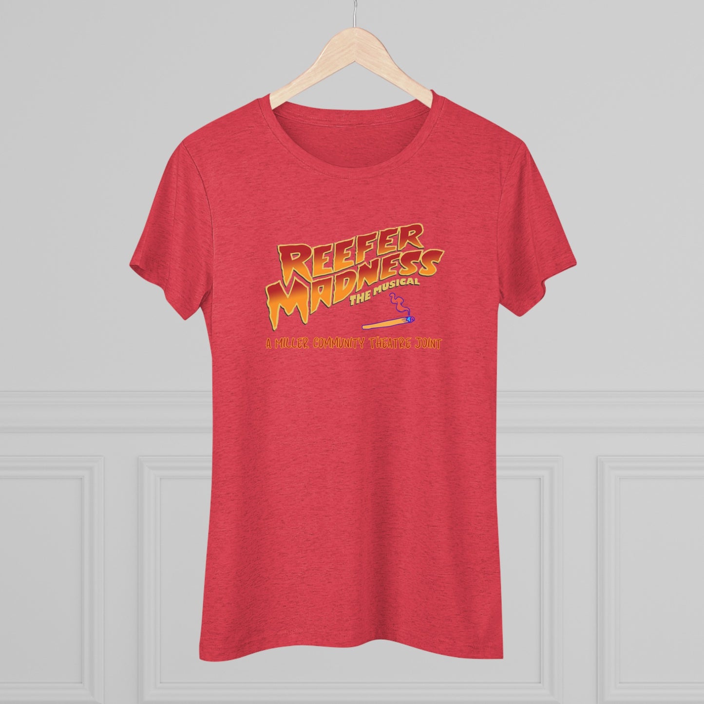 This limited-edition dark gray "Reefer Madness Cast Shirt - Miller Community Theatre - Women's Triblend Tee" by Printify features the text "Reefer Madness: The Musical" in bold, fiery letters across the chest. Below, in smaller orange text, it reads, "A Hill's Community Theatre Joint.