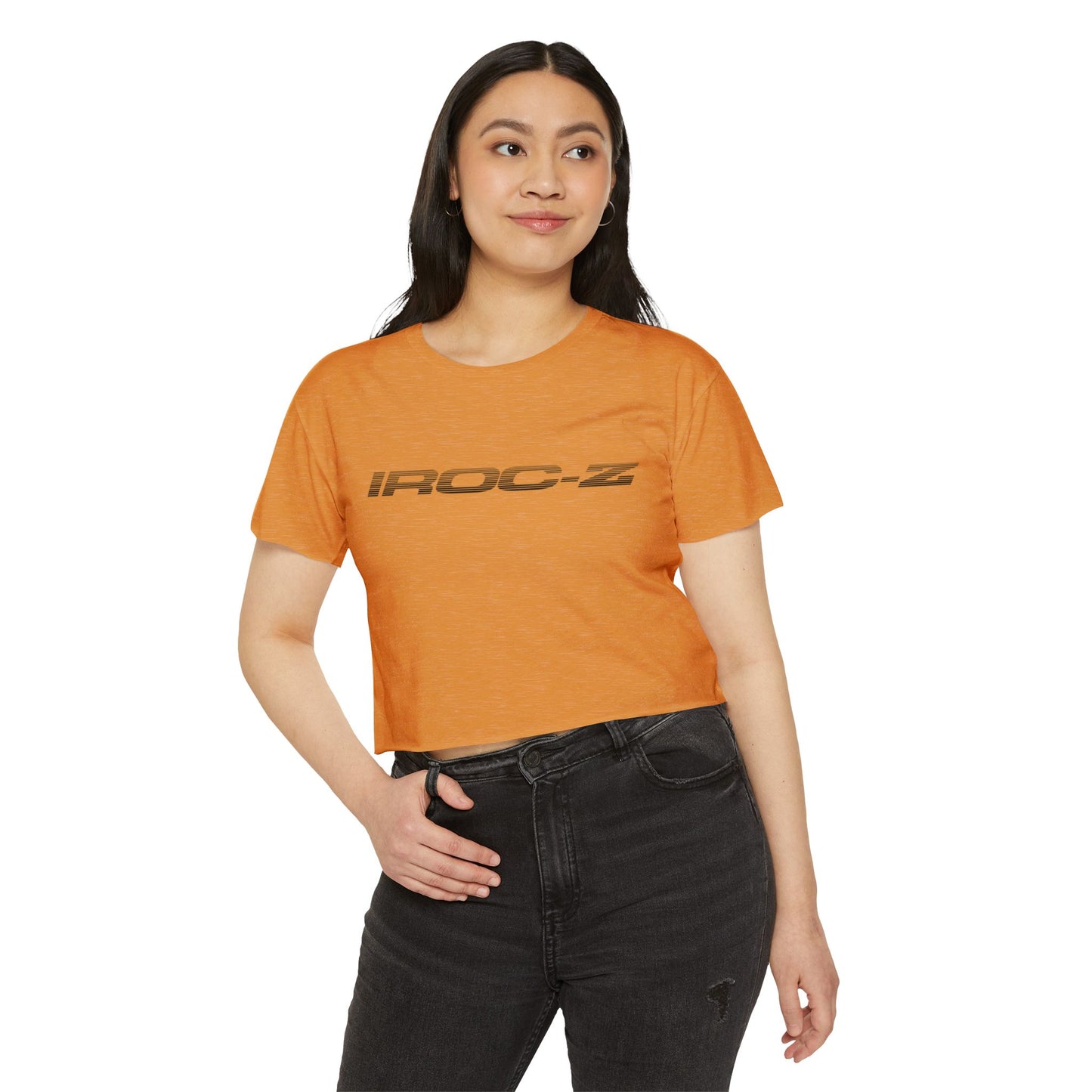 A grey, short-sleeve, rounded-neckline Women's Festival Crop Top by Printify, featuring "IROC-Z" printed in bold black letters across the chest. Perfect for any festival, this Chevrolet Iroc Z-inspired top from the 1980s stands out against a plain white background.