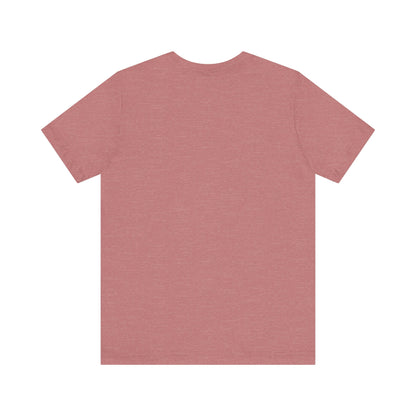 A light blue Printify "The Tinder Box 1980s" unisex jersey short sleeve tee featuring the "Tinder Box" logo in the center. The logo consists of a dark shield with the words "Tinder Box" in white text, with a small flame icon replacing the dot above the "i".