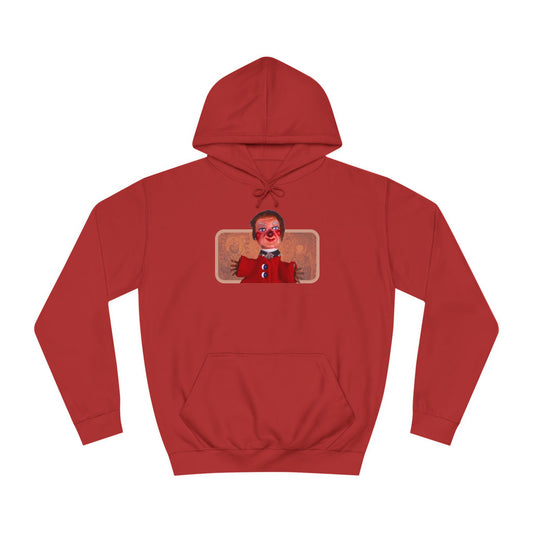 The Printify Lady Elaine Fairchilde Unisex Hoodie in vibrant red features a small rectangular depiction of the cherished character from the Neighborhood of Make-Believe. Made from soft Airlume cotton, it highlights a cartoonish figure with a red face and clay-like appearance set against two decorative patterns.