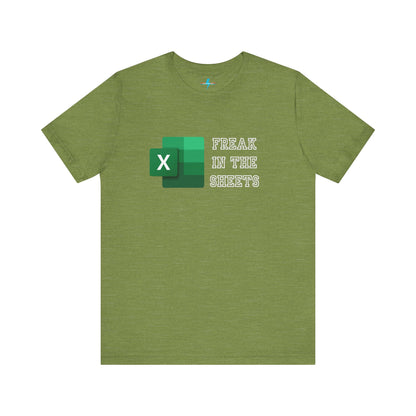 A green Freak in the Sheets - Excel - Unisex Jersey Short Sleeve Tee from Printify, featuring the Microsoft Excel logo on the left. The text next to the logo reads, "FREAK IN THE SHEETS" in white, bold, all-caps letters, making it perfect for spreadsheet enthusiasts. The shirt is laid flat against a plain white background.