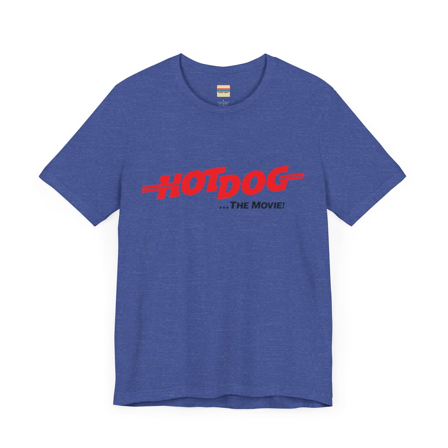 A smiling man and woman interact while wearing matching yellow "Hot Dog The Movie 1984 - Unisex Jersey Short Sleeve Tee" by Printify, featuring bold red "HOT DOG THE MOVIE" text. Their vibrant tees perfectly complement their blue jeans, with the man casually having his hands in his pockets and the woman resting one hand on his shoulder.