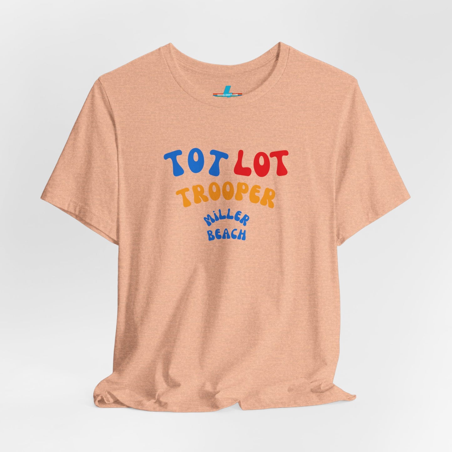 A green unisex jersey short sleeve tee from Printify, featuring colorful text on the front that reads "TOT LOT TROOPER MILLER BEACH" in blue, red, yellow, and orange letters. The shirt is displayed against a plain white background.