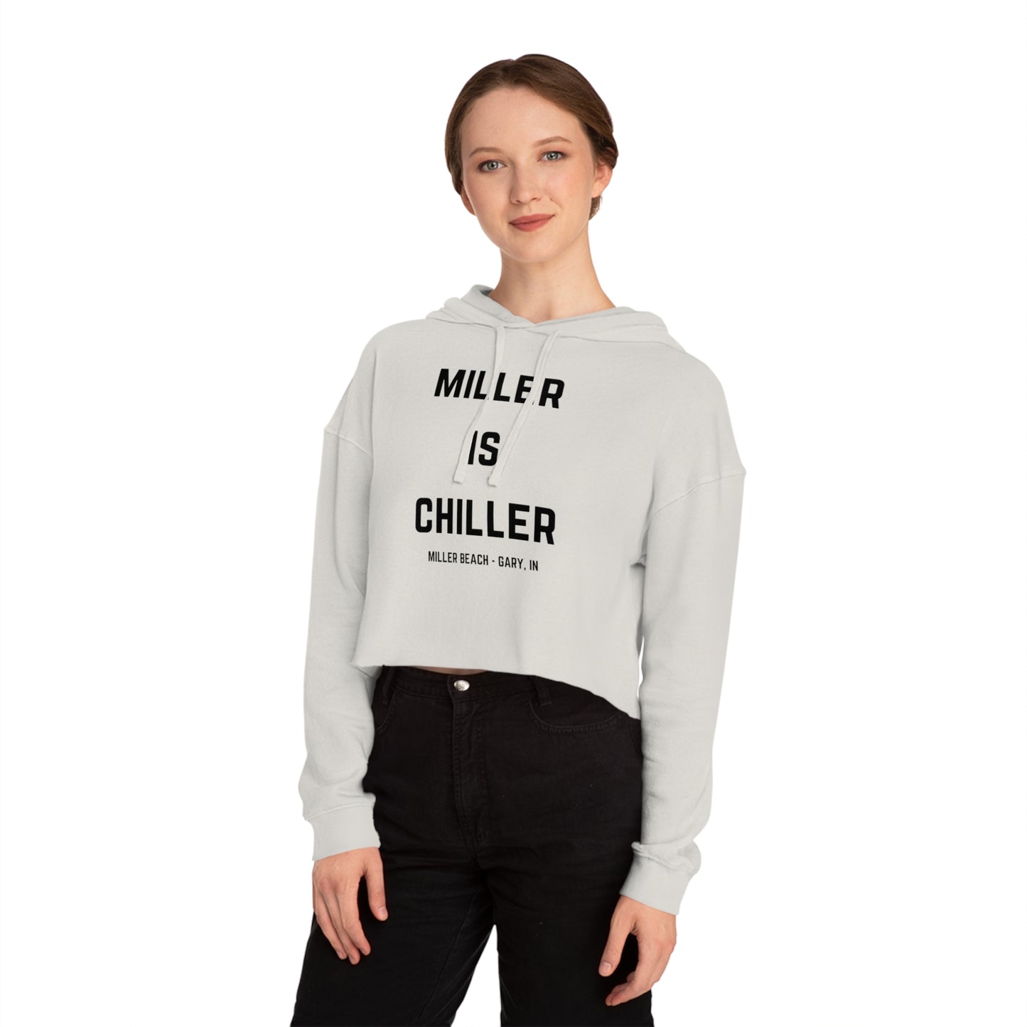 A white Women's Cropped Hooded Sweatshirt by Printify, featuring the phrase "MILLER IS CHILLER" printed in bold black letters on the front. Below the phrase, it says "MILLER BEACH • GARY, IN" in smaller black text. The SoCool Shirts hoodie includes a drawstring hood and long sleeves.