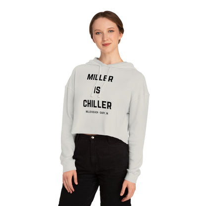 A white Women's Cropped Hooded Sweatshirt by Printify, featuring the phrase "MILLER IS CHILLER" printed in bold black letters on the front. Below the phrase, it says "MILLER BEACH • GARY, IN" in smaller black text. The SoCool Shirts hoodie includes a drawstring hood and long sleeves.