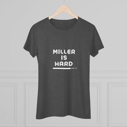 The Miller is Hard - Miller Beach Women's Triblend Tee by Printify features unique red coloring with white text that reads "MILLER IS HARD" and "GARY, IN" below, showcasing distinctive lettering spacing and alignment. Made from ultra-soft fabric, this shirt ensures a comfortable fit with a simple, casual design.