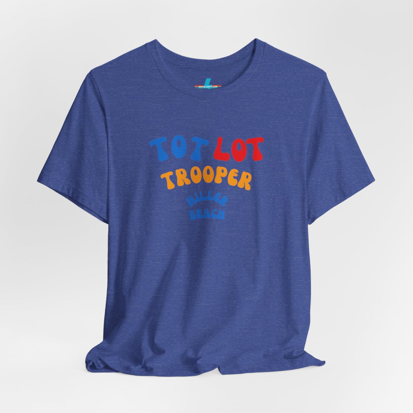 A green unisex jersey short sleeve tee from Printify, featuring colorful text on the front that reads "TOT LOT TROOPER MILLER BEACH" in blue, red, yellow, and orange letters. The shirt is displayed against a plain white background.