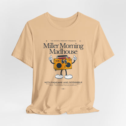 This Printify unisex jersey short sleeve tee in Sand Dune features a playful boombox cartoon character with arms, legs, and sunglasses. Emblazoned with "Miller Morning Madhouse," it highlights podcast details from "The School Podcast Presents.