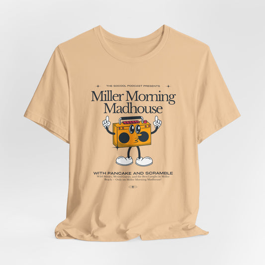 This Printify unisex jersey short sleeve tee in Sand Dune features a playful boombox cartoon character with arms, legs, and sunglasses. Emblazoned with "Miller Morning Madhouse," it highlights podcast details from "The School Podcast Presents.