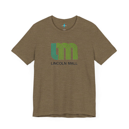 A light green unisex jersey short sleeve tee by Printify features "LINCOLN MALL" written under a retro-styled green and blue curved line design, celebrating the 70s and 80s shopping era in Lincoln Mall Matteson.