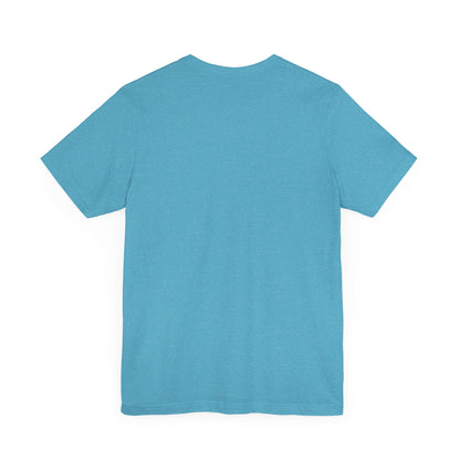 A light blue Printify "The Tinder Box 1980s" unisex jersey short sleeve tee featuring the "Tinder Box" logo in the center. The logo consists of a dark shield with the words "Tinder Box" in white text, with a small flame icon replacing the dot above the "i".