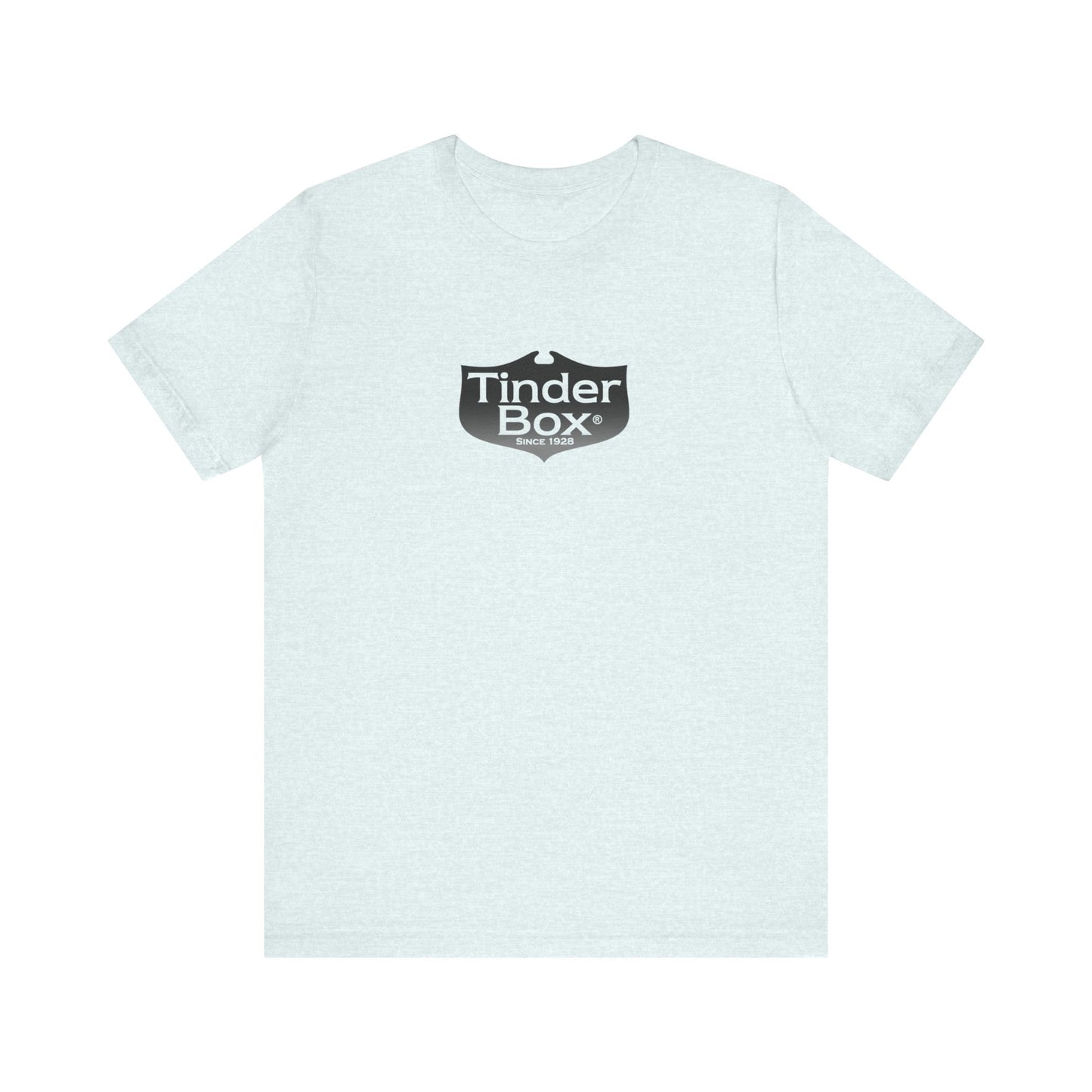 A light blue Printify "The Tinder Box 1980s" unisex jersey short sleeve tee featuring the "Tinder Box" logo in the center. The logo consists of a dark shield with the words "Tinder Box" in white text, with a small flame icon replacing the dot above the "i".