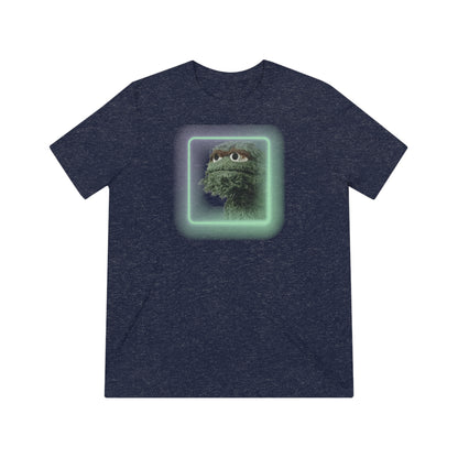 Introducing the Oscar the Grouch Unisex Triblend Tee by Printify: This red triblend t-shirt features a green puppet character with expressive eyes, framed by a glowing, square-shaped rainbow border. With its simple and casual design, free of any additional text or graphics, this tee offers the perfect blend of style and durability thanks to its polyester construction.