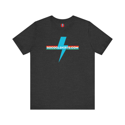 This unisex jersey short sleeve tee by Printify features a striking maroon color with a central light blue lightning bolt design. The text "SOCOOLSHIRTS.COM" is prominently displayed across the lightning bolt in white letters, set against a multicolored background that exudes retro vibes. The shirt is shown laid flat on a white backdrop.