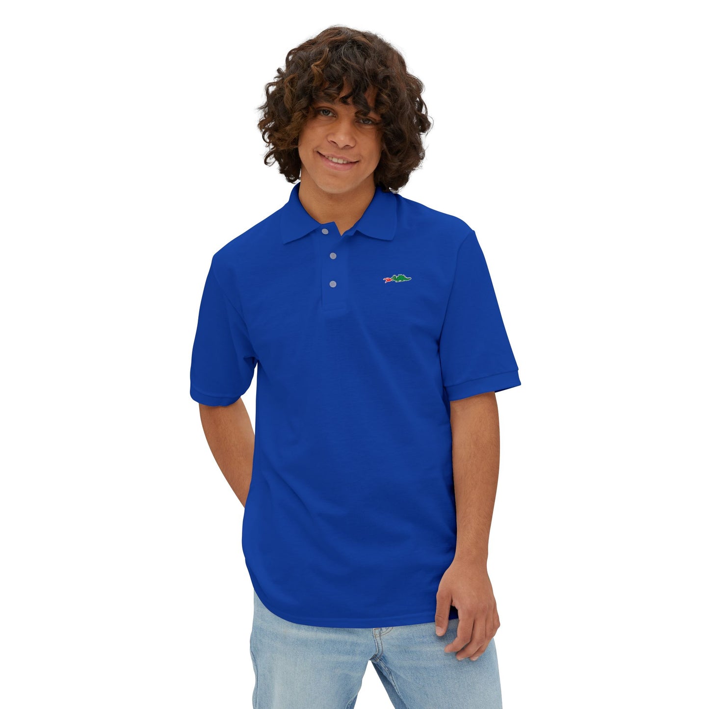 A person with curly hair wearing a navy blue Printify Braggin' Dragon - 1980s Sears Men's Piqué Polo, featuring a small embroidered dragon logo on the left chest, smiles against a plain white background.