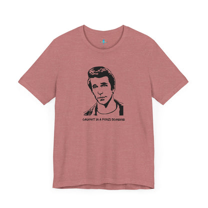 A white unisex jersey short sleeve tee by Printify, named "Caught in a Fonzi Scheme - Happy Days - Retro," features a black and white illustration of a person with a serious expression and styled hair, perfectly capturing the nostalgic apparel vibe. Below the illustration, the text reads "CAUGHT IN A FONZI SCHEME," making it an ideal Happy Days tribute shirt.