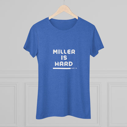 The Miller is Hard - Miller Beach Women's Triblend Tee by Printify features unique red coloring with white text that reads "MILLER IS HARD" and "GARY, IN" below, showcasing distinctive lettering spacing and alignment. Made from ultra-soft fabric, this shirt ensures a comfortable fit with a simple, casual design.