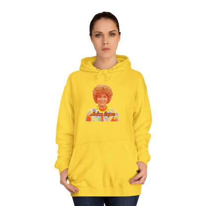 This Helen Roper - Three's Company unisex hoodie by Printify features a lively graphic of a woman with curly hair in a vibrant, patterned outfit. The elegantly scripted text "Mother Rogers" beneath her adds a vintage fashion flair to any wardrobe.