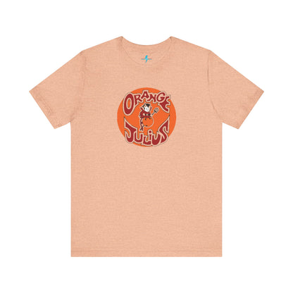 The Orange Julius 1980's Logo Unisex Jersey Style T-Shirt from Printify boasts a light gray color and features a vintage-style graphic. The design showcases the text "Orange Julius" in a stylized font within an orange circle, along with a small cartoon character holding a drink at the center—a nostalgic nod to timeless refreshment.