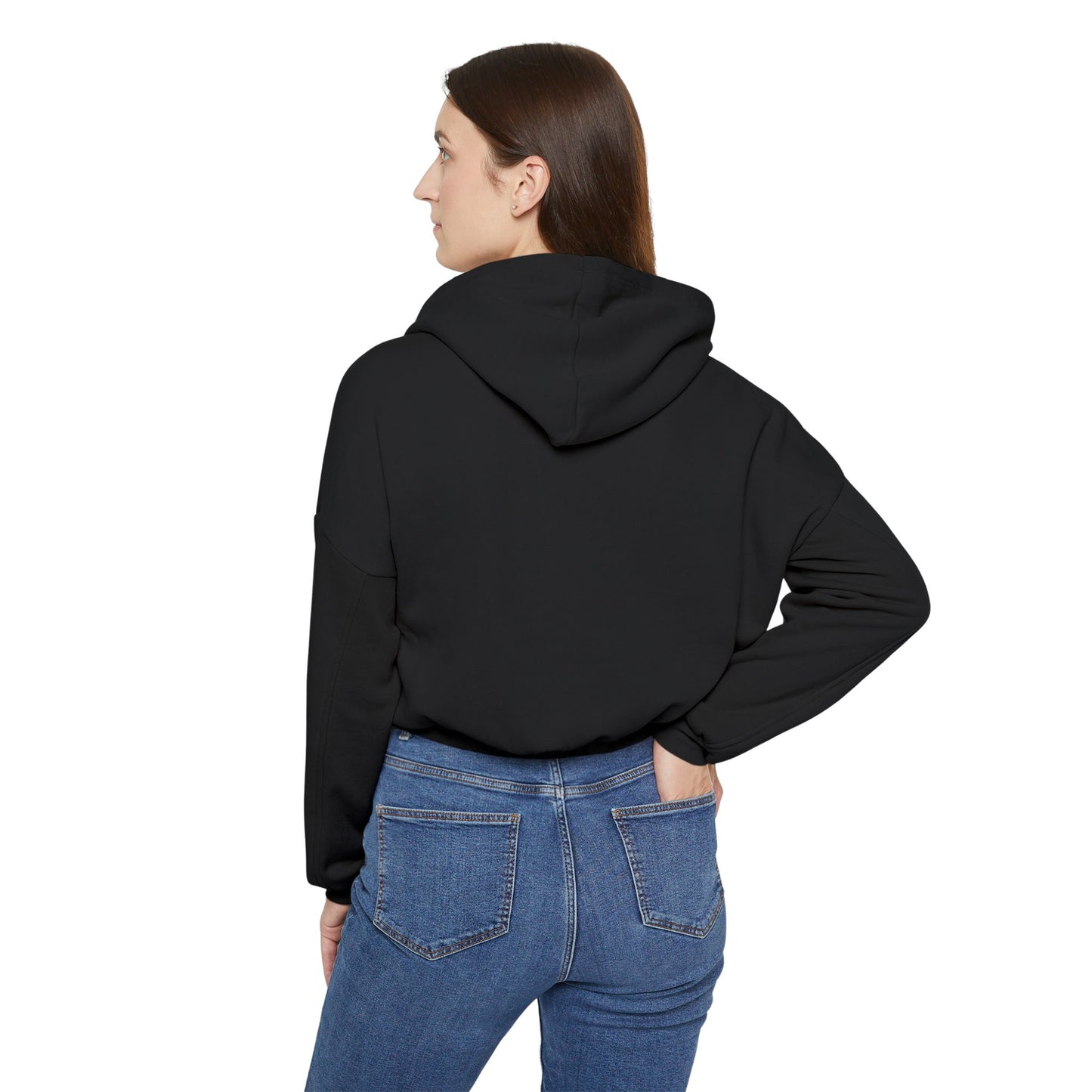 A person confidently stands in front of the camera with one hand on their hip, wearing a Printify "Say Perhaps to Drugs" Women's Cinched Bottom Hoodie. Crafted from soft Airlume cotton, this light-colored cropped hoodie pairs stylishly with blue jeans.