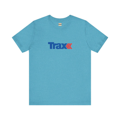 A gray unisex jersey short sleeve tee from Printify, inspired by retro 1980s Kmart style. The "Trax" logo is printed in blue letters, followed by three red arrows pointing to the right. This classic Trax Brand T-shirt is laid flat against a white background, capturing nostalgic fashion vibes.