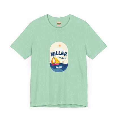 The Miller Beach Sailboat - Unisex Jersey Short Sleeve Tee by Printify features a vibrant graphic design portraying a sailboat on water with a sun above it and the text "MILLER beach 46403." This white retail fit shirt is crafted from soft Airlume combed cotton and showcases rounded graphics in blue, orange, and yellow.