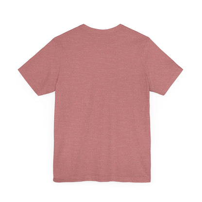 A light blue Printify "The Tinder Box 1980s" unisex jersey short sleeve tee featuring the "Tinder Box" logo in the center. The logo consists of a dark shield with the words "Tinder Box" in white text, with a small flame icon replacing the dot above the "i".