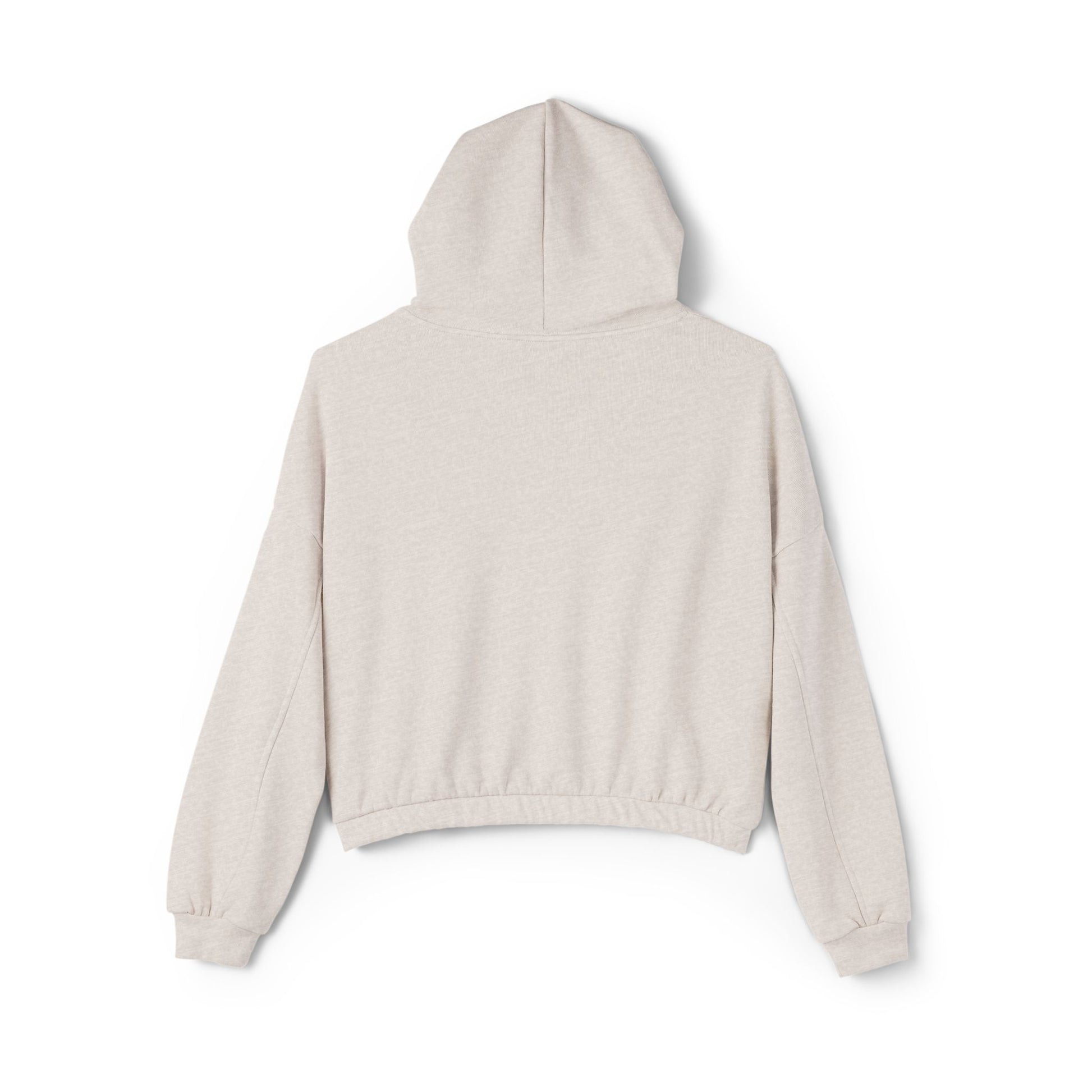 A person confidently stands in front of the camera with one hand on their hip, wearing a Printify "Say Perhaps to Drugs" Women's Cinched Bottom Hoodie. Crafted from soft Airlume cotton, this light-colored cropped hoodie pairs stylishly with blue jeans.