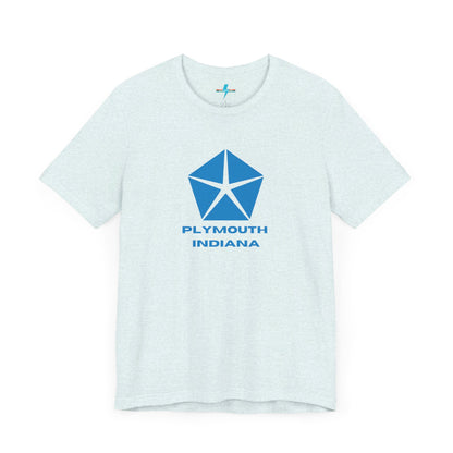 A black Printify Plymouth, Indiana Chrysler Logo T-shirt is displayed against a plain white background. The shirt features a blue, five-point star emblem reminiscent of a vintage autos design above the text "PLYMOUTH INDIANA" in blue, centered across the front. The shirt is laid out flat with the sleeves slightly bent.