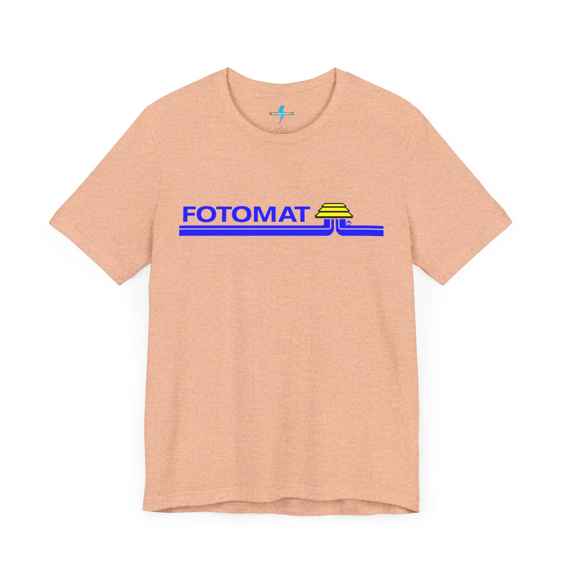 The Fotomat 1970s Retro T-Shirt by Printify is a dark gray short-sleeve shirt that features the word "FOTOMAT" in bold blue capital letters and a blue and yellow graphic design resembling layered lines and an upside-down triangle. This Tshirt captures the essence of 80s nostalgia with its centered, retro design.