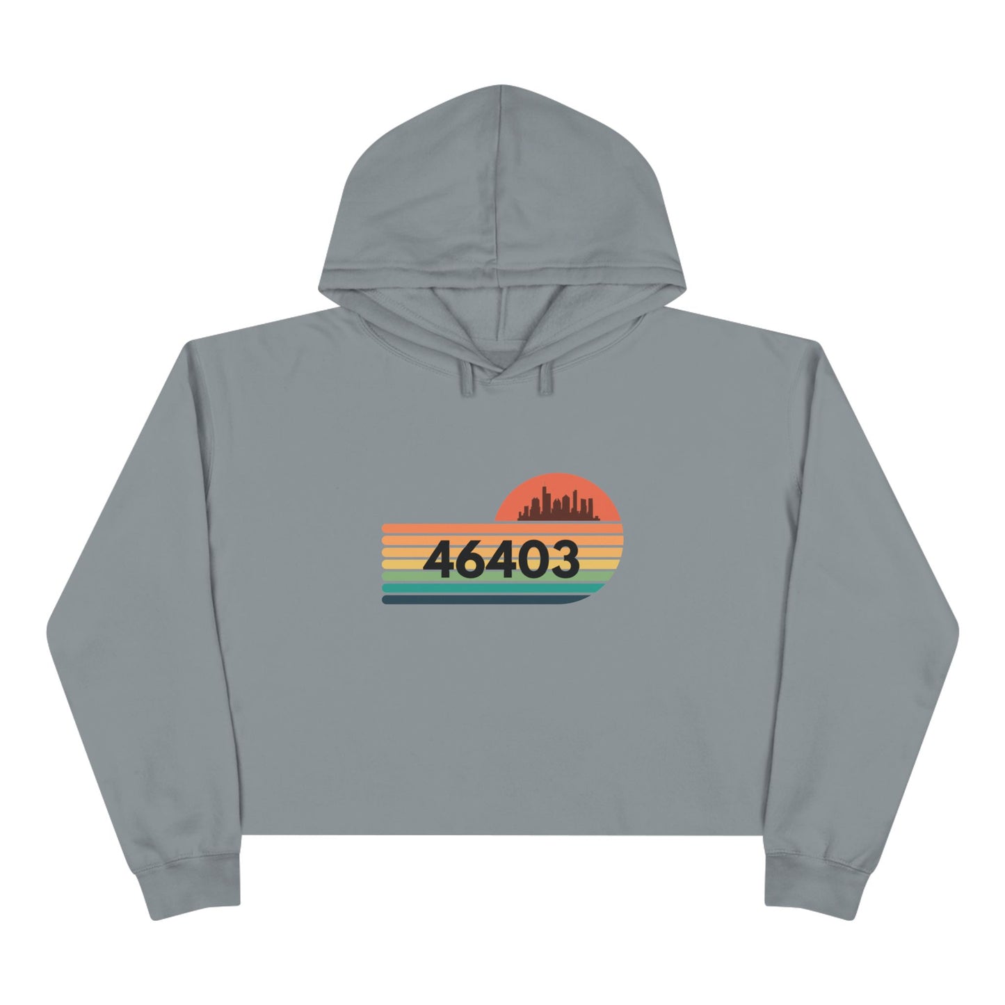 The Miller Beach 46403 Women's Crop Hoodie by Printify features a nostalgic design with a city skyline silhouette and the iconic "46403" zip code, set against a striped sunset backdrop in vibrant orange, green, and yellow hues that capture the essence of Miller Beach.