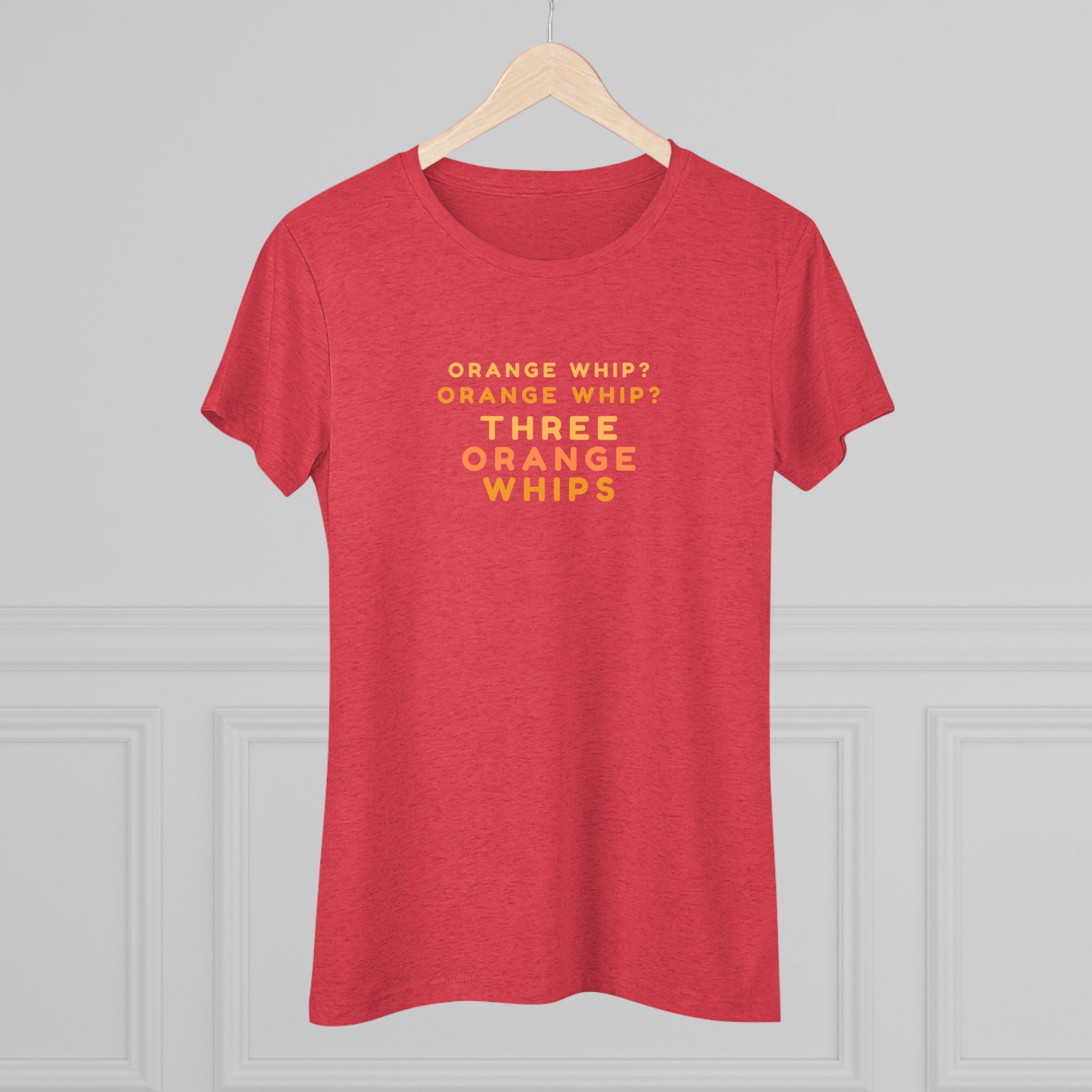 This Blues Brothers women's triblend tee from Printify features a dark gray vintage look with the text "ORANGE WHIP? ORANGE WHIP? THREE ORANGE WHIPS" printed in bright orange and yellow in the center. With a round neck and short sleeves, it's perfect for that retro vibe.