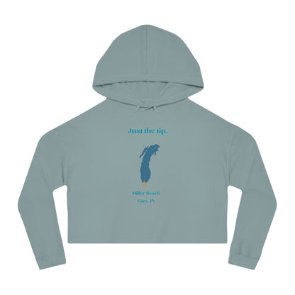 The "Just the Tip - Miller Beach - Women’s Cropped Hooded Sweatshirt" by Printify is designed in black camo with high-quality tri-blend fabric, showcasing a blue map shape and a yellow star. It features the phrase "Killer Beach" along with references to "Gary, IN," embodying the spirit of Miller Beach adventures.