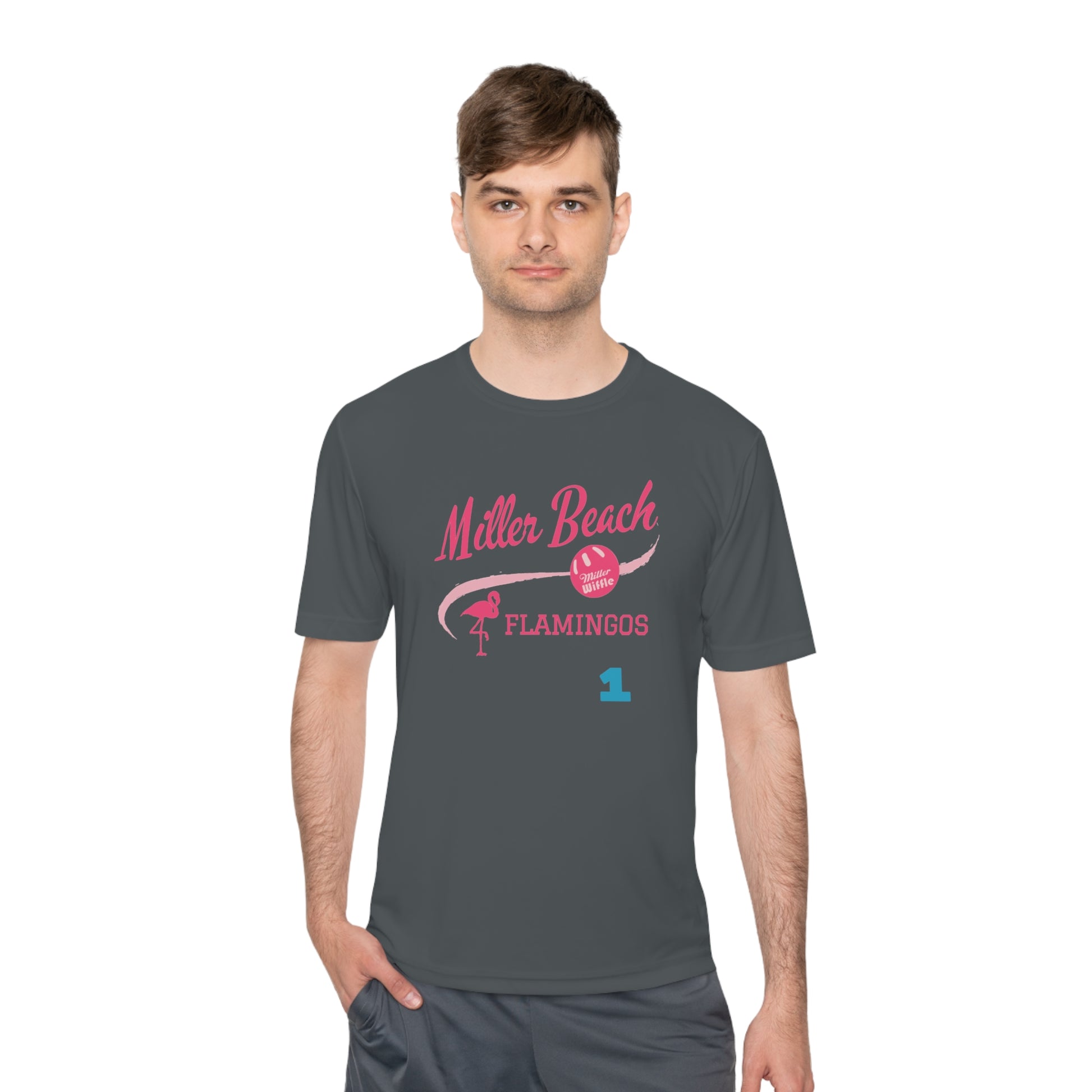 Introducing the "Miller Beach Flamingos - Jackson 01" Unisex Moisture Wicking Tee by Printify. This beige T-shirt showcases "Miller Beach" in a pink cursive font accompanied by a small pink flamingo illustration. Below, "FLAMINGOS" is displayed in bold pink capital letters, with a blue "01" on the bottom right corner. As part of the Sport-Tek PosiCharge Competitor collection, this lightweight shirt provides superior moisture-wicking performance.