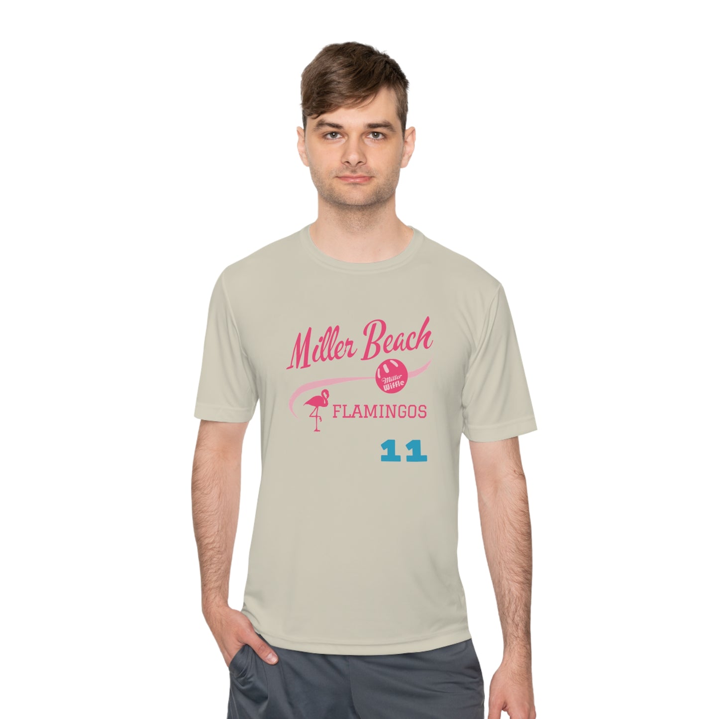 The Miller Beach Flamingos - Poncin 11 Unisex Moisture Wicking Tee by Printify features a beige shirt with "Miller Beach" in pink script, accompanied by a small illustration of a flamingo and volleyball. Below this design, the word "FLAMINGOS" is displayed in pink, with the number "11" appearing in blue near the bottom. Made from Sport-Tek PosiCharge Competitor Tee fabric, this custom moisture-wicking shirt ensures you stay cool and stylish.