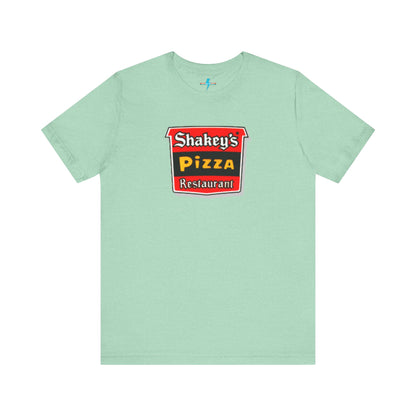 A black Shakey's Pizza - 1980s Retro Logo - Unisex T-Shirt by Printify hangs against a white background. The shirt features a colorful graphic with the text "Shakey's Pizza Restaurant" in white, yellow, and black lettering on a red background, resembling vintage pizza joints signage. This retro tee brings nostalgic vibes of classic pizzerias.