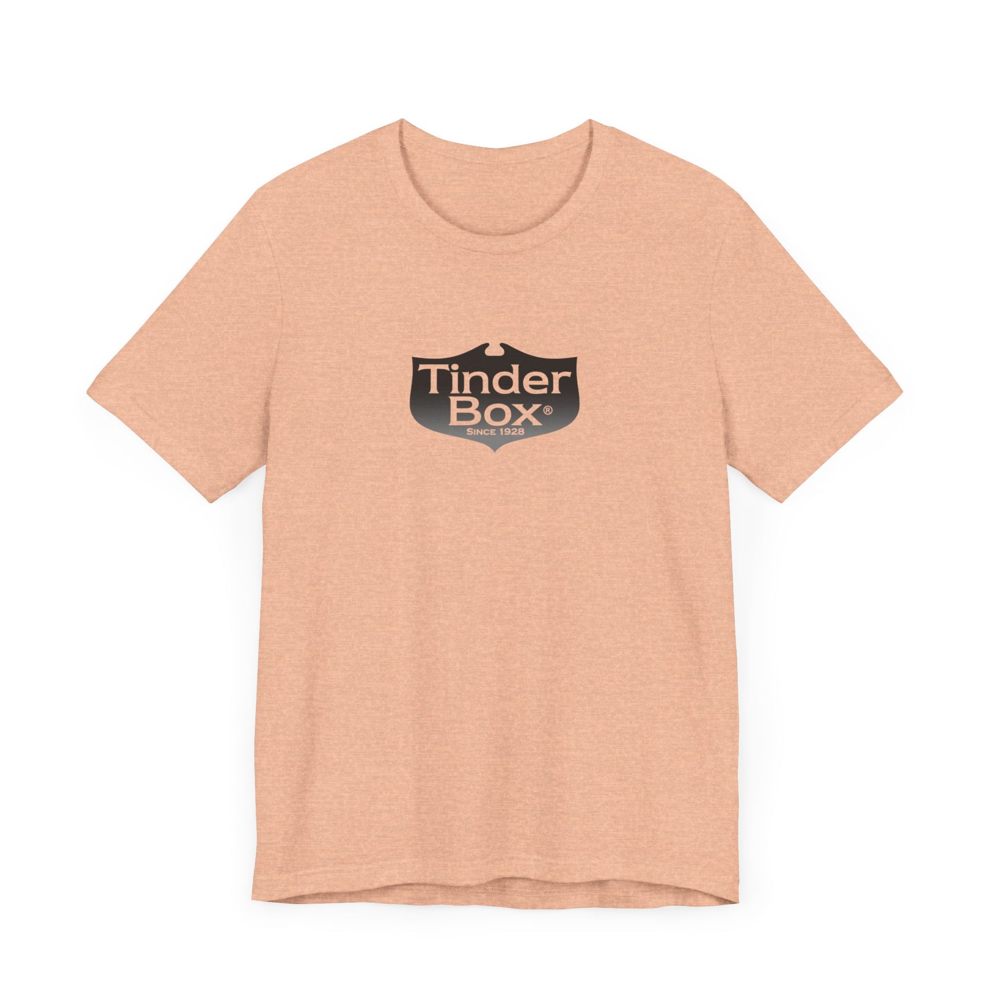 A light blue Printify "The Tinder Box 1980s" unisex jersey short sleeve tee featuring the "Tinder Box" logo in the center. The logo consists of a dark shield with the words "Tinder Box" in white text, with a small flame icon replacing the dot above the "i".