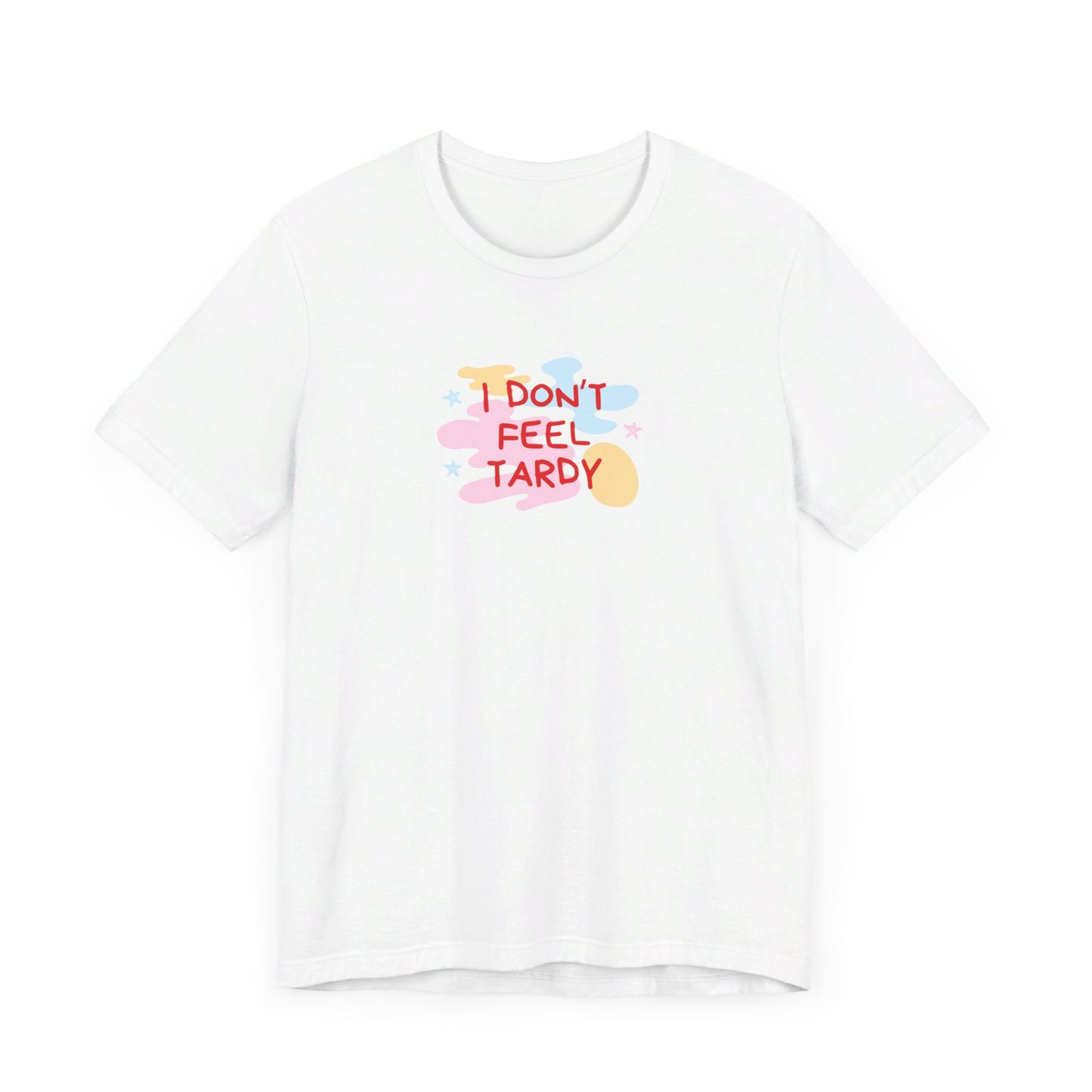 The "I Don't Feel Tardy - 1980s Retro - Unisex Jersey Short Sleeve Tee" from Printify is a light pink jersey shirt that features the bold, colorful text "I DON'T FEEL TARDY" prominently at its center. This design exudes retro vibes with small star shapes and abstract splashes of blue, yellow, and pink, laid flat against a plain background to channel pure Van Halen T-shirt energy.