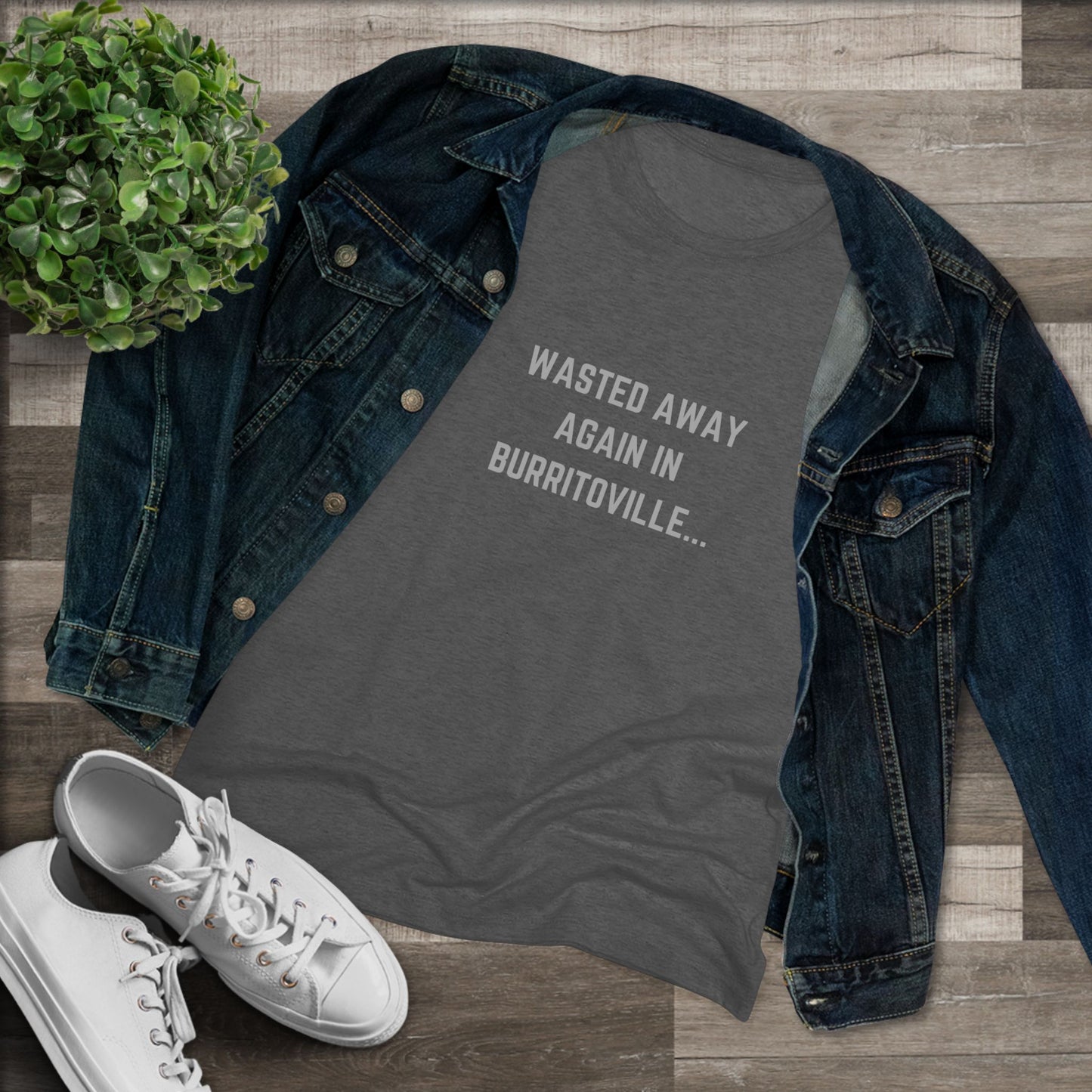 The Women's Triblend Tee from Printify, named "Wasted Away Again in Burritoville," is a dark gray heather vintage t-shirt featuring short sleeves and a crew neck. The front showcases the text "WASTED AWAY AGAIN IN BURRITOVILLE..." printed in white capital letters. This nostalgic piece from the 1980s is neatly displayed on a flat surface against a white background.