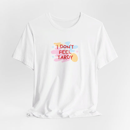 The "I Don't Feel Tardy - 1980s Retro - Unisex Jersey Short Sleeve Tee" from Printify is a light pink jersey shirt that features the bold, colorful text "I DON'T FEEL TARDY" prominently at its center. This design exudes retro vibes with small star shapes and abstract splashes of blue, yellow, and pink, laid flat against a plain background to channel pure Van Halen T-shirt energy.