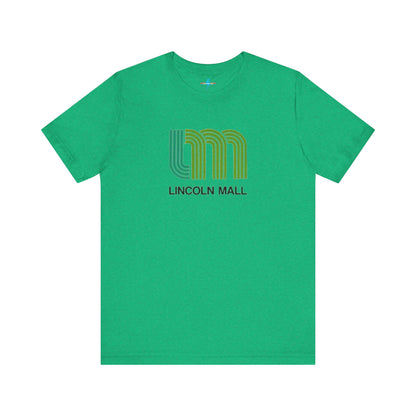 A light green unisex jersey short sleeve tee by Printify features "LINCOLN MALL" written under a retro-styled green and blue curved line design, celebrating the 70s and 80s shopping era in Lincoln Mall Matteson.