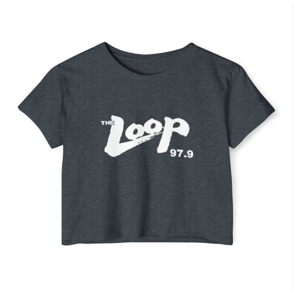 Printify's Women's Festival Crop Top features a grey design with short sleeves and a round neckline. The crop top displays the text "The Loop 97.9" in white, with the word "Loop" styled in a brushstroke-like font—ideal for fans of Chicago’s iconic rock radio station who appreciate retro fashion.